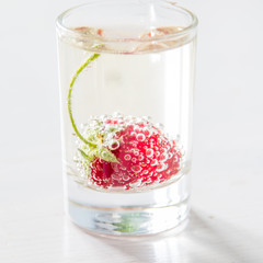 Strawberry lemonade ingredients with mint, white wood background