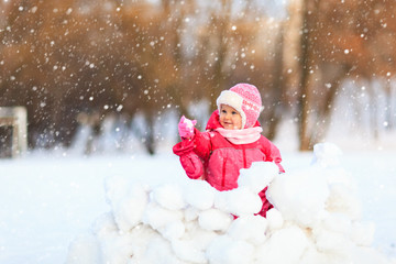 cute happy little girl play in winter