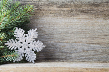Obraz na płótnie Canvas Christmas decoration with fir branches on the wood background.