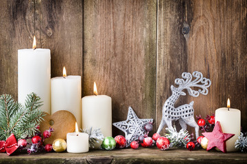 Christmas Advent candles with festive decor.