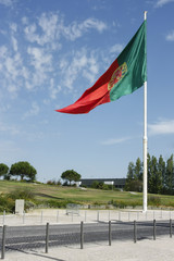 Fototapeta premium Flag of Portugal waving, against blue sky
