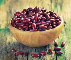 Red beans in the wooden bowl on old wooden