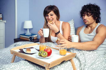 Obraz na płótnie Canvas Couple having breakfast in bed served over tray