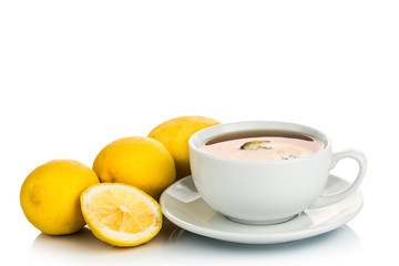 Refreshing hot tea with lemon slice on white background