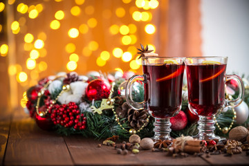 Fototapeta na wymiar Christmas hot mulled wine with spices on a wooden table. The idea for creating greeting cards