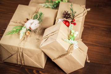 Christmas gift box with red ribbon on dark wooden background in vintage style