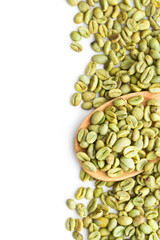 green coffee beans in wooden spoon