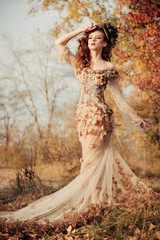 Beautiful woman in autumn park