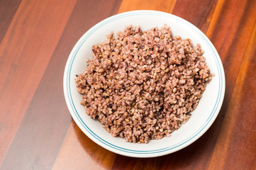ten cereal rice in a plate on wooden table