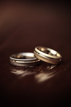 wedding rings on wooden table