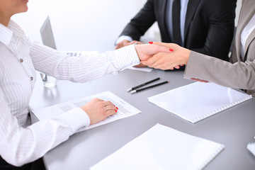 Business people shaking hands, finishing up a meeting. Copy space  at the left corner