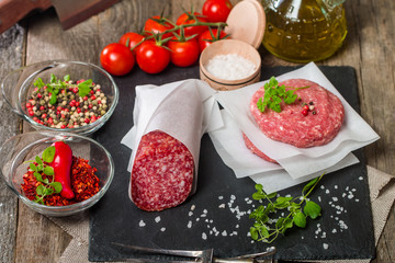 Raw Ground meat Burger and salami