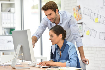Business people working in office on desktop computer