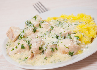 chicken breast in a creamy sauce with mashed potatoes