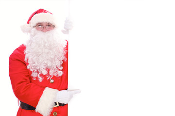 Kind Santa Claus pointing in white blank sign, isolated on white background