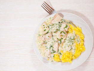 chicken breast in a creamy sauce with mashed potatoes
