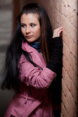 Fototapeta premium portrait of a girl near the wall