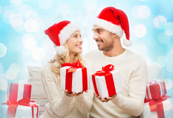 happy couple at home exchanging christmas gifts