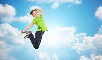 smiling boy jumping in air
