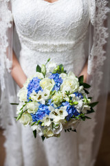 Beautiful wedding a bouquet in hands of the bride