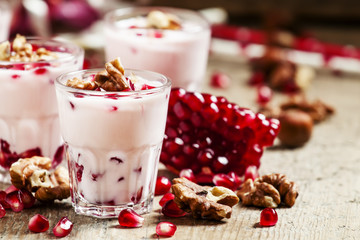 Homemade garnet yogurt with walnuts and pomegranate seeds, selec