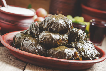 Traditional Greek dolma with meat in grape leaves, yogurt sauce,