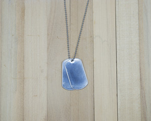 military dog tags on wood background