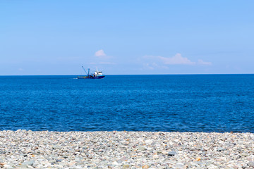 Fishing boat heading out to the ocean in the early morning