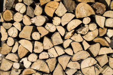 Dry chopped firewood logs in a pile