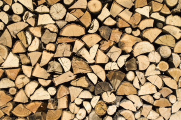 Dry chopped firewood logs in a pile
