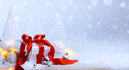 art Christmas balls and gift box on snow