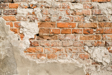 Close up of old brick wall with grey plaster