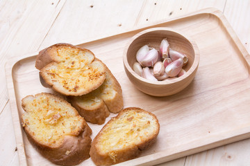 crispy garlic bread in wood tray