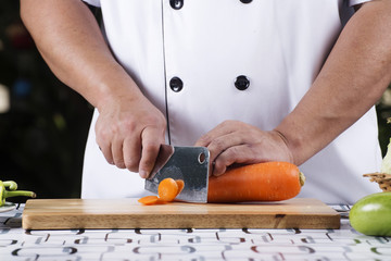 Chef cutting carrot