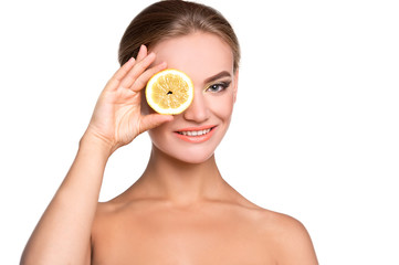 Young emotional beautiful woman with lemon in her hands. Perfect skin