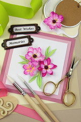 Handmade greeting card and assorted scrapbooking or  card making tools and materials
