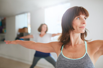 Woman doing the warrior pose during yoga class