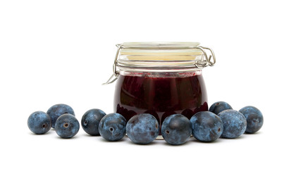 plums and plum jam in the bank on a white background