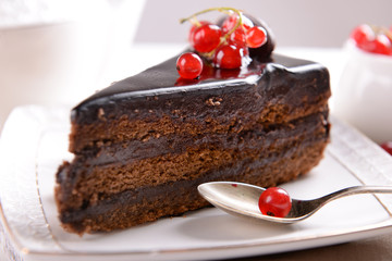 Tasty chocolate cake with berries on table close up