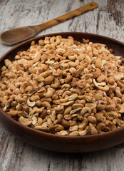 Raw cashews close-up in wooden bowl