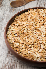 Peanuts. Close up of fried, peeled and salted peanuts in a wooden plate