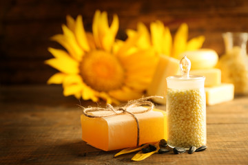 Soap bar and Spa treatments and sunflower on wooden background