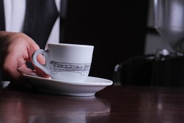Close up of waitress hands preparing espresso coffee. Service and restaurant concept