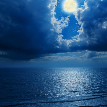 full moon in dramatic clouds and sea