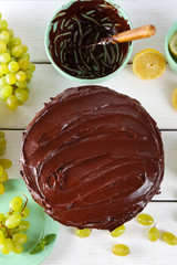 composition of sweet chocolate dessert and fruits on light-blue wooden background