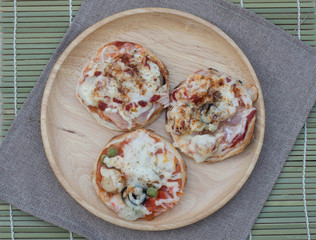Homemade pizza with ham and tomatoes, served with spatula on woo