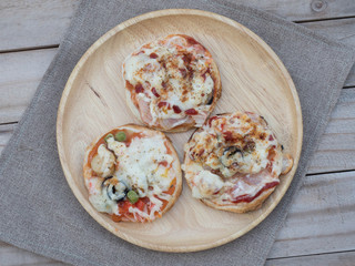 Homemade pizza with ham and tomatoes, served with spatula on woo