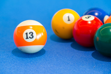 orange snooker ball with number thirteen on it with other colorf