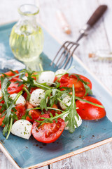 Vegetable salad,cherry tomatoes,, mini mozzarella, arugula. selective focus