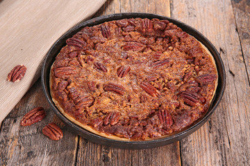 pecan pie on wood background